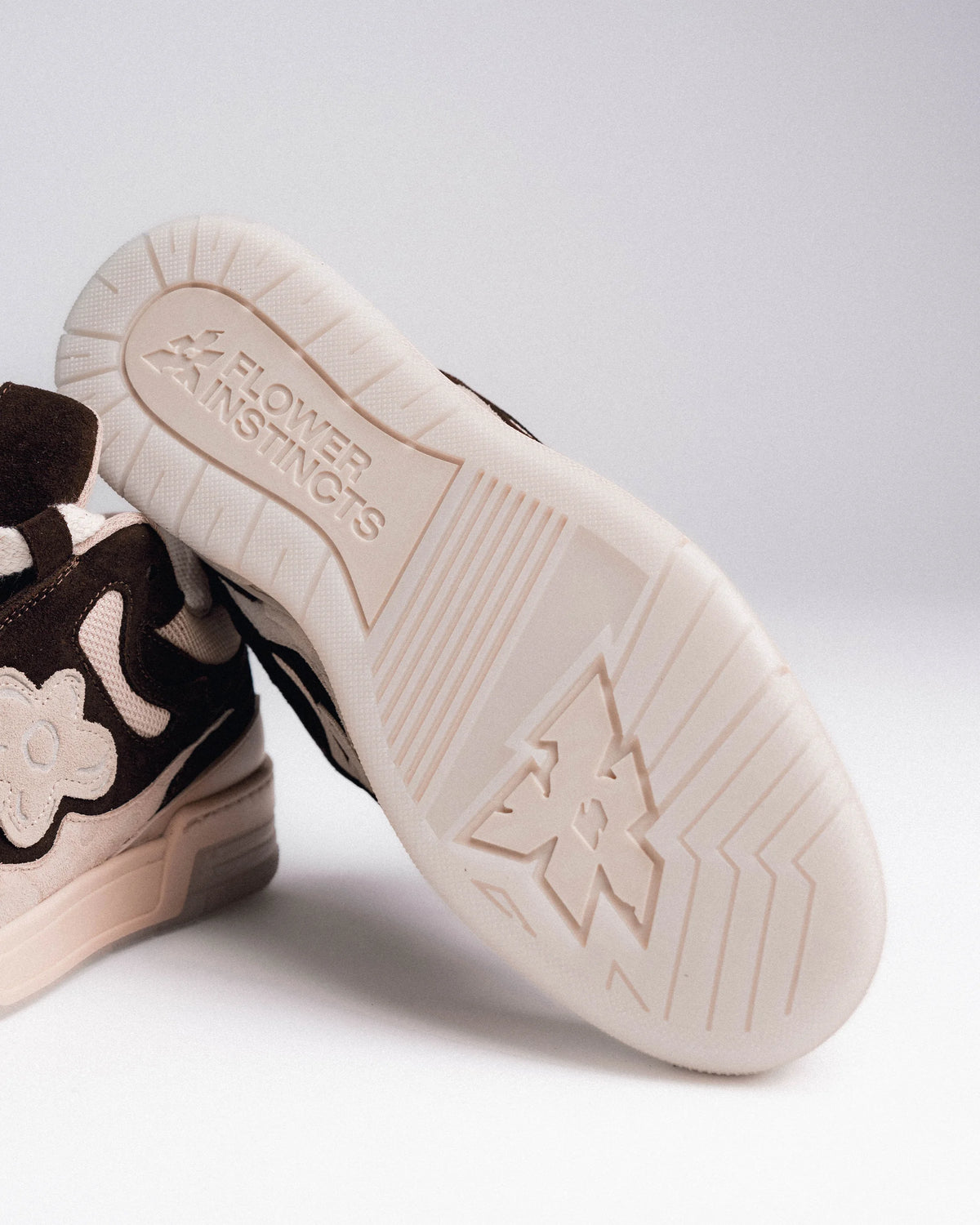 A translucent outsole, the Flower pressed into it. A double wedge underneath, for all-day cushioning.