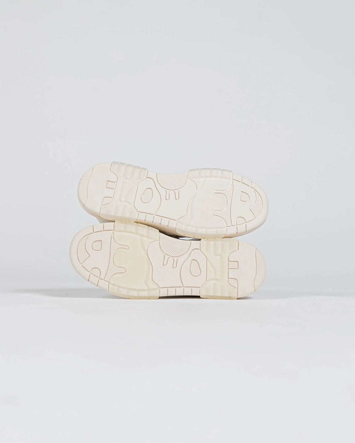 Flower Instincts is molded into the underside of the translucent gum outsole.