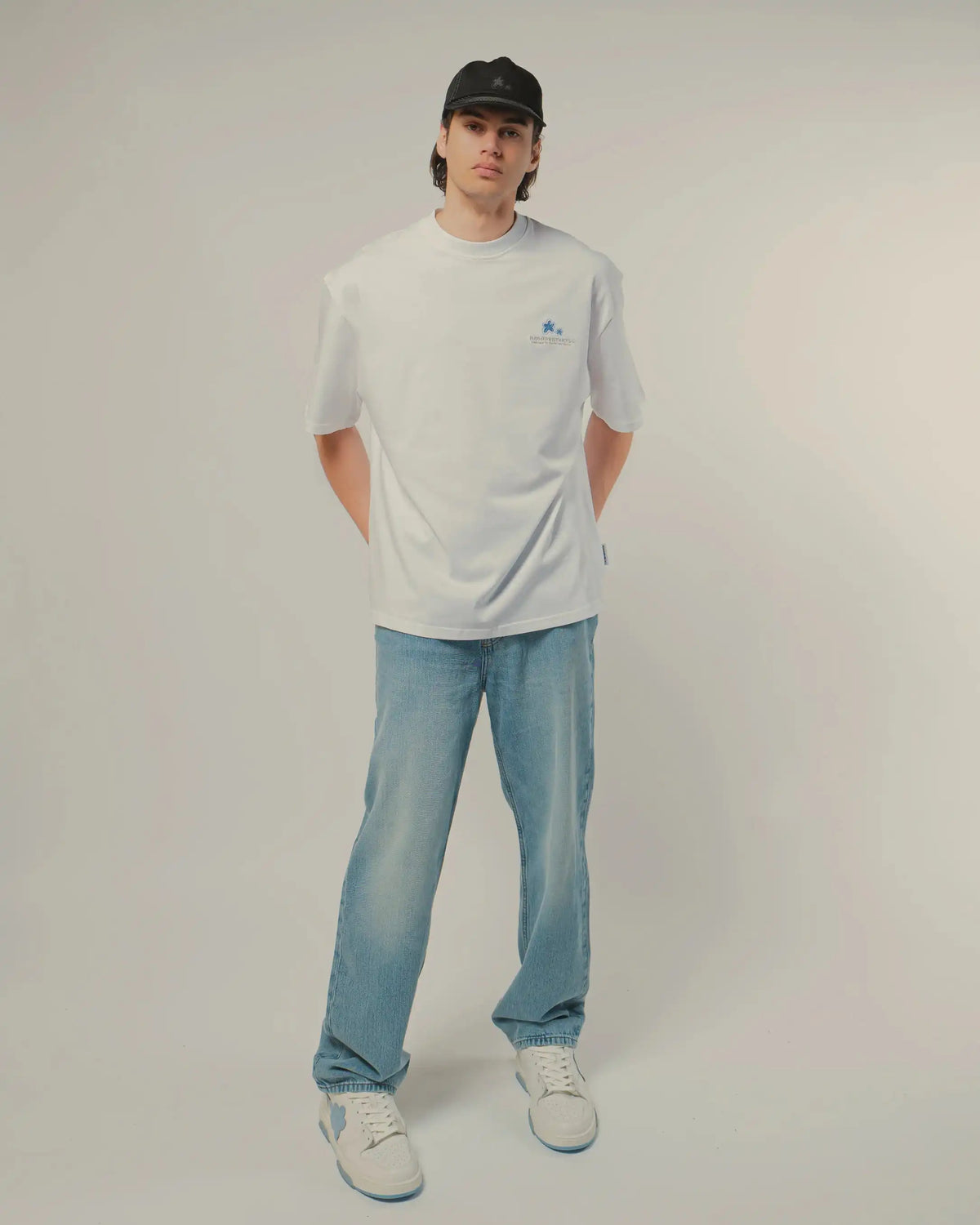 Tee 101 Crystal worn, front, full length with light blue jeans and white sneakers