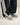 Flower Instincts Daytona Concrete sneaker worn with black trousers